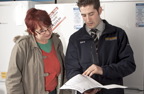 Photograph of woman shopping in an electrical shop speaking to a salesman