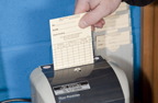 Photograph of a person clocking in or out of work